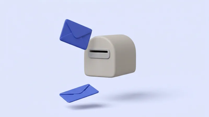 A blue envelope turned back in mid-air beside the slot of a grey letterbox, with a second blue envelope fallen below it