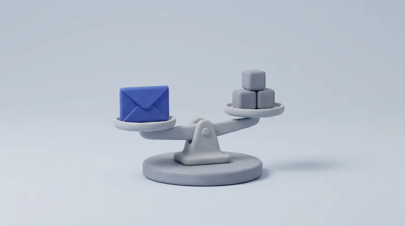 A grey balance scale holding a blue envelope on one pan and three small grey cubes on the other