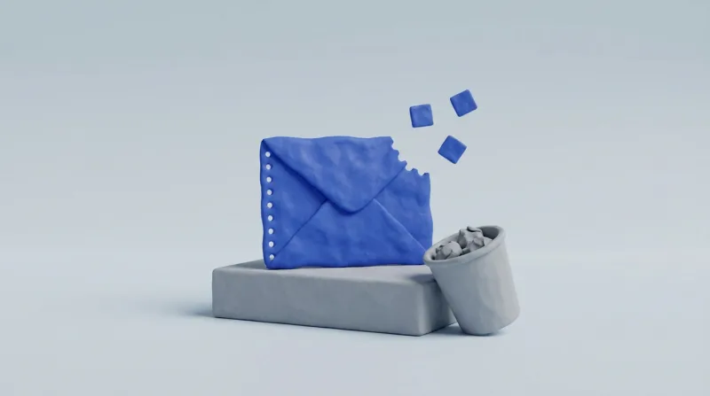 A blue envelope with a perforated edge and a torn-off corner drifting away as small squares, on a grey pedestal beside a small grey bin