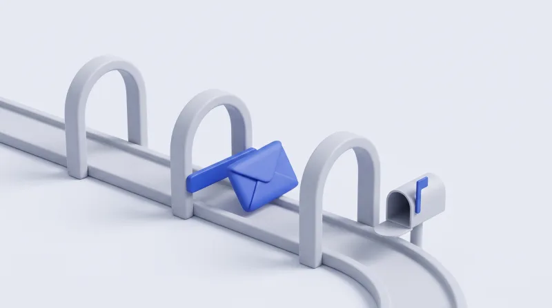 A blue envelope stopped by a lowered barrier under the middle of three arches, with an open, empty mailbox waiting at the end of the track